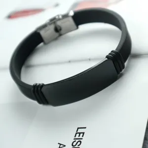 Minimalist men's black silicone bracelet featuring an adjustable stainless steel ID plate