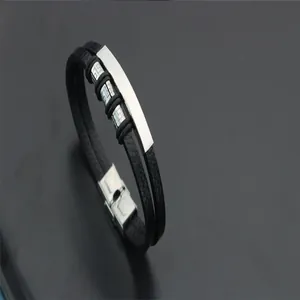 Detailed view of a double-layered black braided leather bracelet with a stainless steel bar