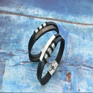 Detailed view of woven leather stainless steel couple bracelets with Love engraving