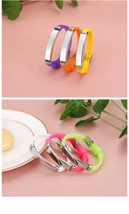Detailed view of colorful adjustable silicone bracelets with curved metal ID plates.