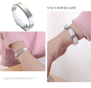 Detail of white silicone bracelet with engravable stainless steel plate for DIY