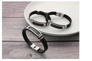 Detailed view of trendy stainless steel and black silicone bracelets for stylish men.