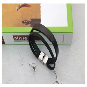 Detailed close-up of a black braided leather men's bracelet with stainless steel plate