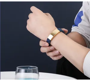 Close-up showing the fit of a men's blue silicone bracelet with golden stainless steel plate