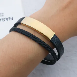 Men's customizable stainless steel bracelet with black braided leather strap on wrist