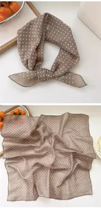 Detailed view of coffee polka dot silk square scarf showing soft texture and folds