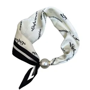 Elegant black and white silk square scarf featuring a decorative pearl buckle