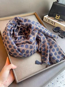Detail view of Bohemian sun protection scarf with blue dot leopard print and tassels