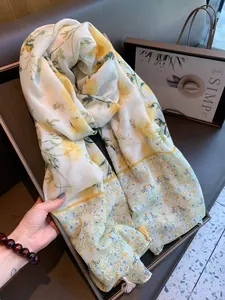 Elegant Bohemian floral sunscreen shawl with intricate yellow flower patterns for women