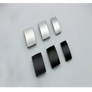 Macro view of matte black and silver curved stainless steel ID tag hardware for pets