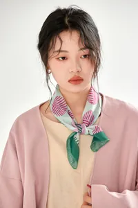 Detailed view of a vintage French-style printed cotton square scarf on a model.