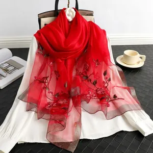 Red silk wool blend scarf with elegant rose embroidery and shimmering gold edges