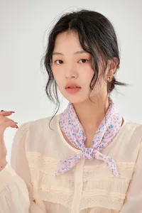Elegant vintage pink floral cotton neckerchief styled on a model for a chic French look