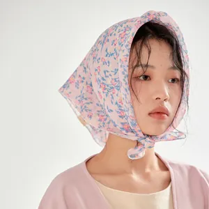 French vintage floral cotton headscarf worn by a model in a soft lighting studio setting