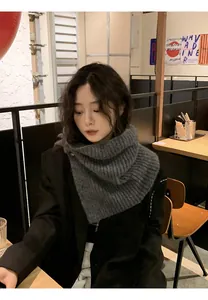Cozy dark grey knitted neck warmer scarf with button detail on an Asian female model
