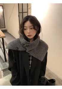 Stylish close-up of a retro grey knitted scarf with button details on a model