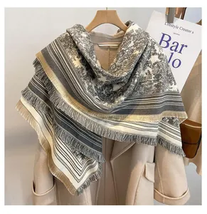 Detail showing a large square pashmina shawl with Toile de Jouy print and fringed edges