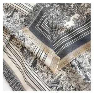 Close-up detail view of a vintage forest print large square shawl with elegant fringe edges