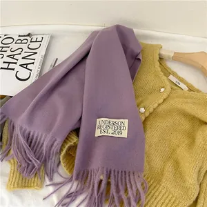 Detailed close-up of a soft purple imitation cashmere scarf with stylish fringes