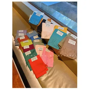 Soft solid color faux cashmere scarves with tassels available in multiple vibrant colors