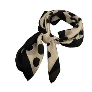 Retro beige and black polka dot silk scarf for women tied in a knot