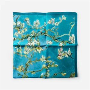 High-quality detail view of a turquoise square silk scarf with Van Gogh's Almond Blossoms