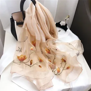 Elegant champagne silk scarf featuring delicate floral and butterfly embroidery details
