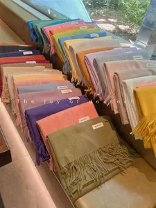 Detailed view of soft colorful scarves with fringe in various vibrant pastel shades
