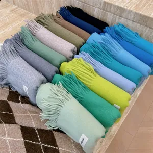 Collection of soft solid color winter scarves with fringes in various vibrant colors