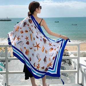 Lightweight seaside beach shawl with marine shell and starfish print pattern in blue