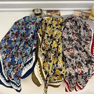 Detailed view of three 90cm floral cotton linen scarves in blue, yellow, and red.