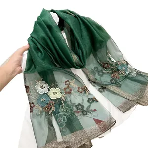 Elegant green silk blend scarf with colorful floral embroidery and gold glitter edge