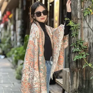 Bohemian ethnic style shawl with paisley pattern and tassels worn by woman in street
