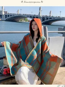 Elegant retro plaid hooded cloak poncho for women shown in a scenic outdoor setting