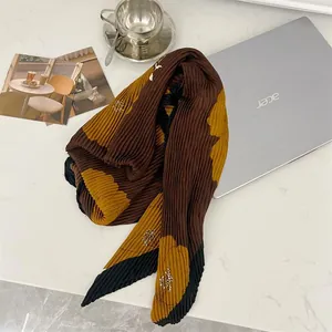 Close-up detail of 90cm pleated cotton linen square scarf featuring elegant floral print pattern