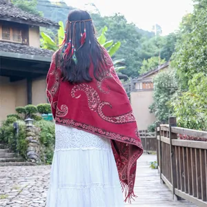 Ethnic red paisley shawl with fringe for travel photography in autumn and winter