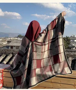 Detailed back view of a red and grey plaid hooded poncho shawl showing the oversized drape