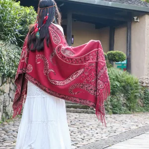 Bohemian deep red paisley shawl with elegant fringe detailing for ethnic travel photos.
