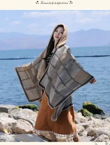 High-quality outdoor detail shot of a vintage checkered hooded cloak with soft fringe