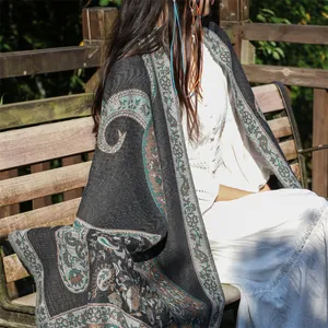 Detailed view of thick ethnic paisley shawl for women in bohemian outdoor setting