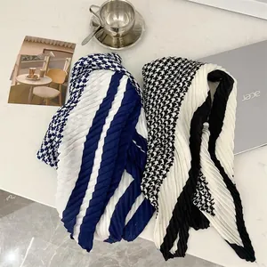 Detail shot of two pleated cotton linen square scarves with houndstooth and striped patterns