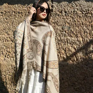 Close-up of thick ethnic shawl with paisley patterns and fringes for travel photos