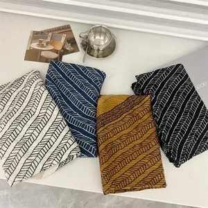 Group of four stylish 90cm pleated square scarves featuring geometric feather patterns