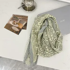 Close-up of elegant cotton-linen pleated square scarf with intricate paisley pattern texture