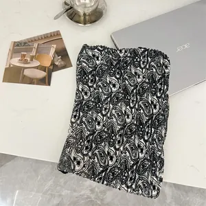 Detail view of cotton linen pleated square scarf with paisley pattern texture.