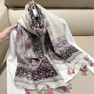 Detailed view of oversized ethnic print scarf with soft leopard and paisley patterns.