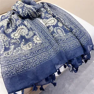 Close-up of navy blue paisley print scarf with delicate fringe tassels