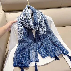 Detail view of retro ethnic cotton linen scarf with blue floral prints and tassels