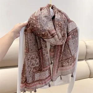 Detail of vintage ethnic paisley print shawl with elegant tassel edges for travel