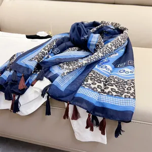 Detailed view of a blue ethnic leopard print shawl with stylish tassel fringe.